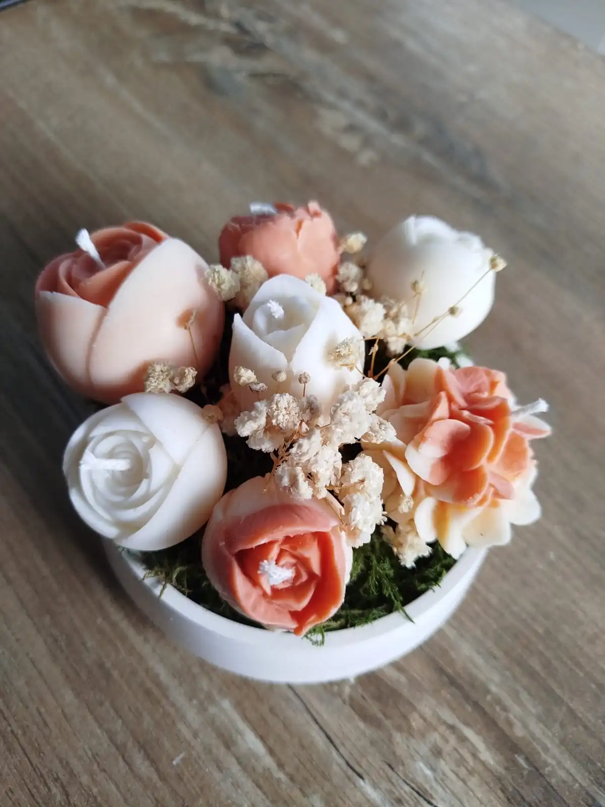 Composition terracotta de bougies en forme de fleurs.